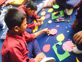 Children involved in creative art and craft at transit home